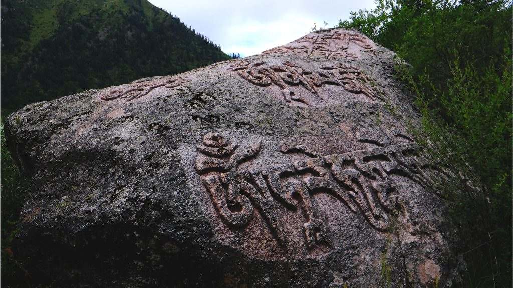 Mani stone carved rocks near the Yilhun Lhatso Lake